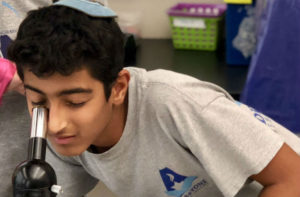 Addlestone Hebrew Academy - Student Looking at Microscope