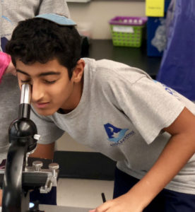 Addlestone Hebrew Academy - Student Looking at Microscope