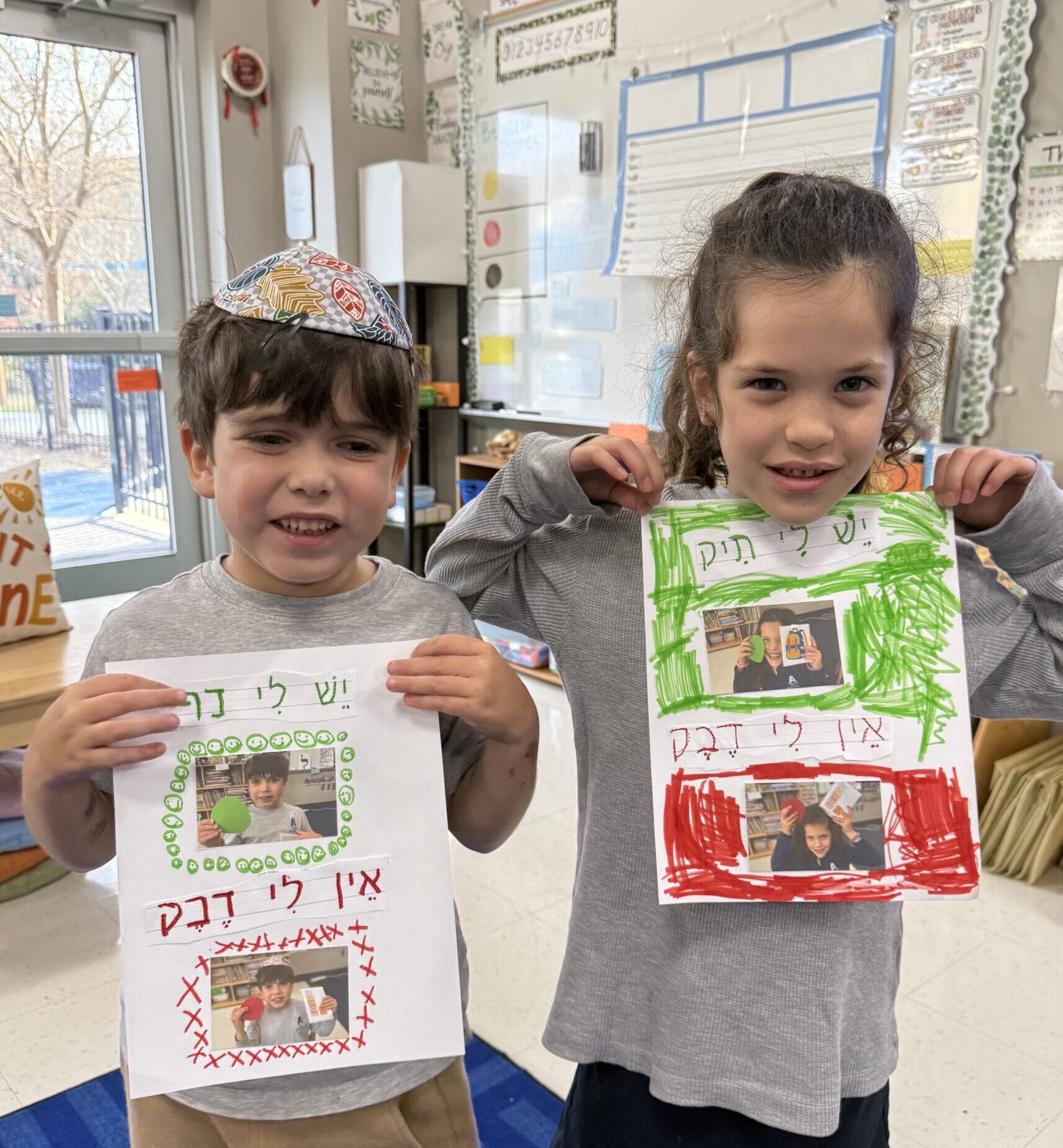 two children showing their school work